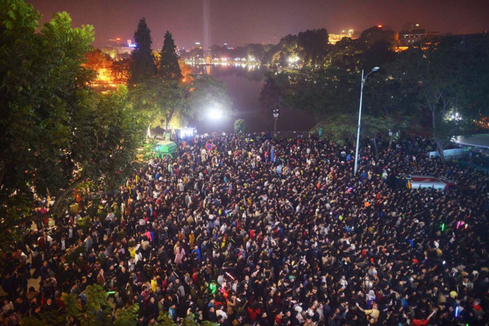 
Hàng nghìn người tập trung bên Hồ Gươm đón chờ thời khắc chuyển giao giữa năm cũ và năm mới. (Ảnh: Quý Đoàn)
