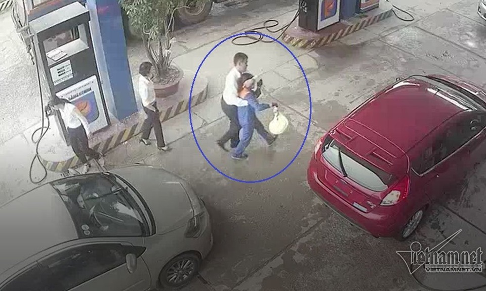 Nam cán bộ ngân hàng đánh rách đầu nữ nhân viên bán xăng - 4 Khách hàng dìu nhân viên bơm xăng đi vào bên trong cửa hàng