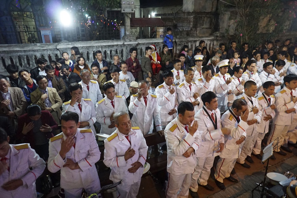 Giáng sinh ấm áp ở nhà thờ trăm tuổi ngoại ô Hà Nội - 6 Các Giáo dân đang làm dấu thánh. Chương trình văn nghệ được bắt đầu từ chập tối tại nhà thờ, kéo dài đến 22h, sau đó bắt đầu vào nghi lễ chính thức.