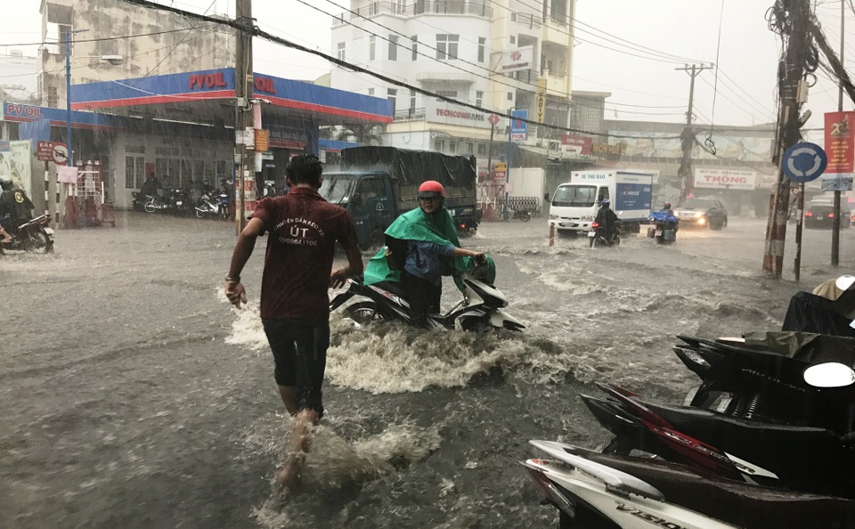 Mưa cực lớn, phía Đông Sài Gòn chìm trong biển nước - 7 Nhiều người đi đường bị té ngã vì nước cuốn xe.