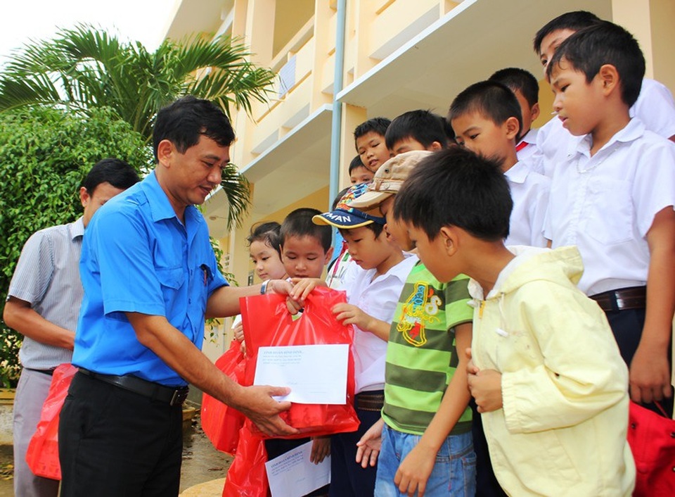 Hàng nghìn bạn trẻ xung kích về vùng lũ giúp dân khắc phục bão lũ - 2 Bí thư Tỉnh đoàn Bình Định Nguyễn Xuân Vĩnh, trao quà cho học sinh vùng lũ