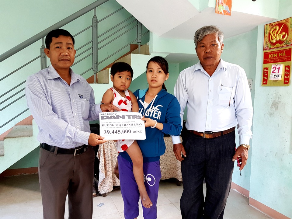 Đại diện lãnh đạo xã Điện Thắng Nam trao tiền của bạn đọc Dân trí đến chị Loan