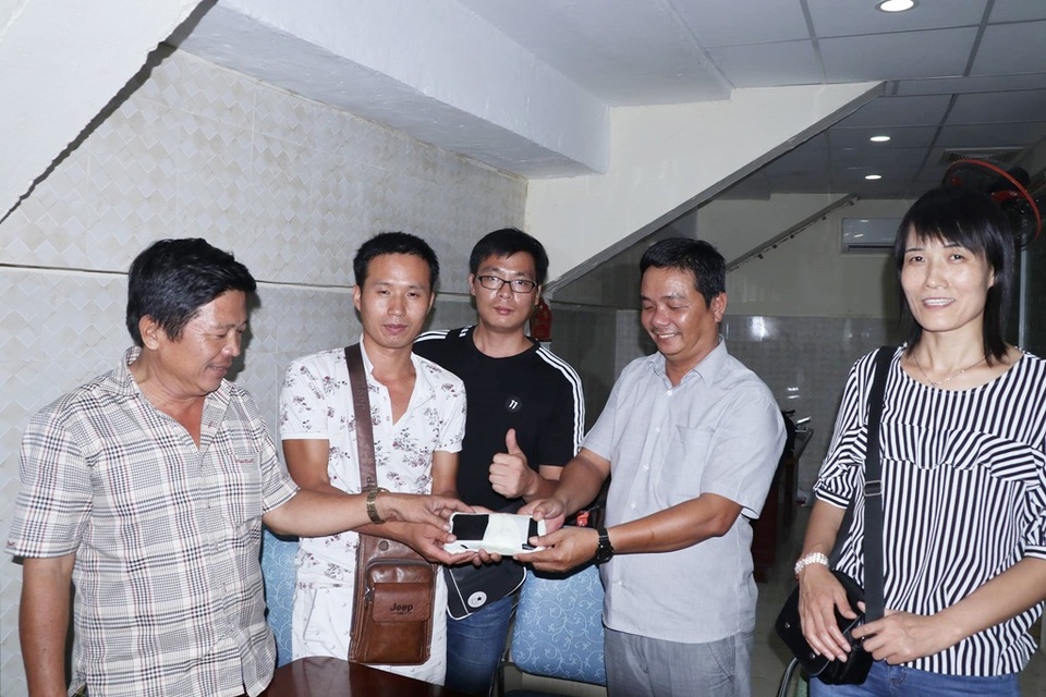 Tài xế xe buýt trả lại 60 triệu đồng cho hành khách Trung Quốc - 1 Anh Thiện (đứng cạnh người phụ nữ) đang trả lại ví cùng hơn 60 triệu đồng cho nhóm du khách Trung Quốc