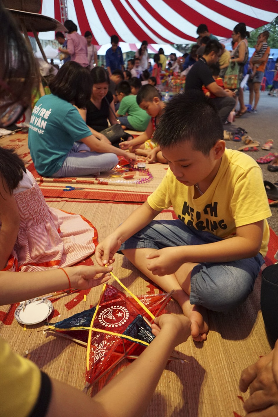 Người lớn, trẻ nhỏ trải nghiệm Tết Trung thu xưa tại Hoàng Thành Thăng Long - 6
Em nhỏ tự làm đèn ông sao nhờ sự hướng dẫn của phụ huynh.