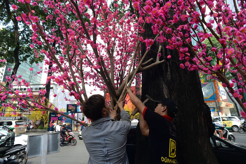 Những công nhân bắt đầu hoàn thiện việc trang trí trên đường phố.