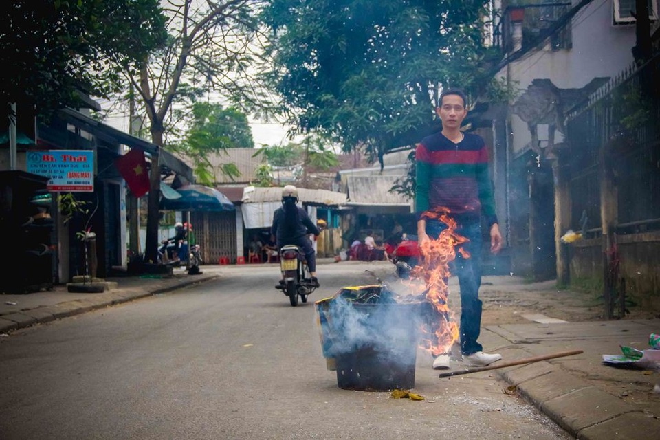 Tục cúng đưa ông bà ngày mùng 3 Tết ở Huế - 5 Một người dân đang đốt vàng mã sau khi làm lễ cúng đưa ông bà