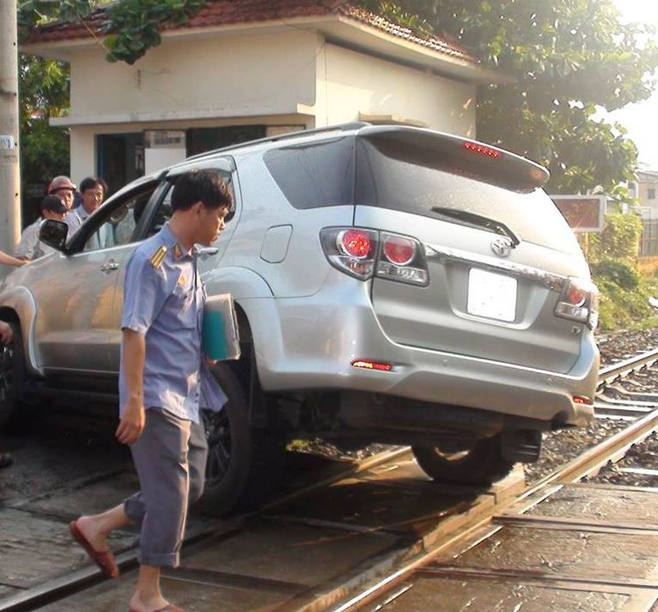 Đoàn tàu dừng khẩn cấp vì ô tô mắc kẹt trên đường ray - 1 Chiếc ô tô 7 chỗ mắc kẹt nằm vắt ngang đường sắt.
