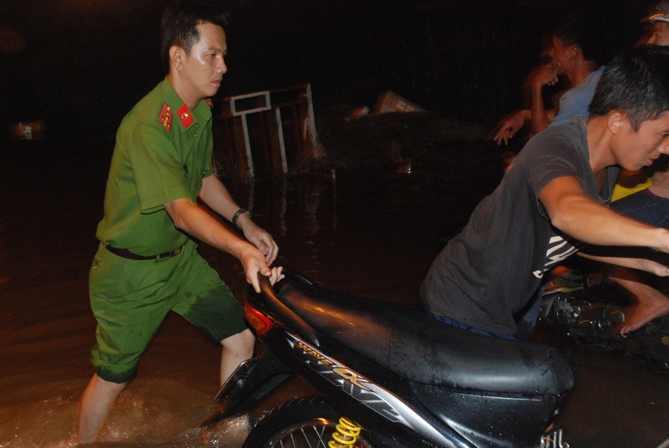 Người Sài Gòn dắt xe lội nước về nhà - 7 Do ngập sâu, lực lượng Công an xã Nhơn Đức cũng có mặt hỗ trợ hướng dẫn, đẩy xe giúp người dân.
