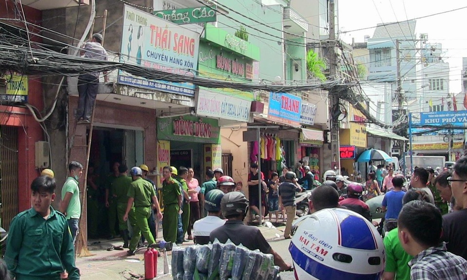 Phá cửa cứu đôi vợ chồng trong cửa hàng thời trang bốc cháy - 1 Người dân tập trung theo dõi vụ việc