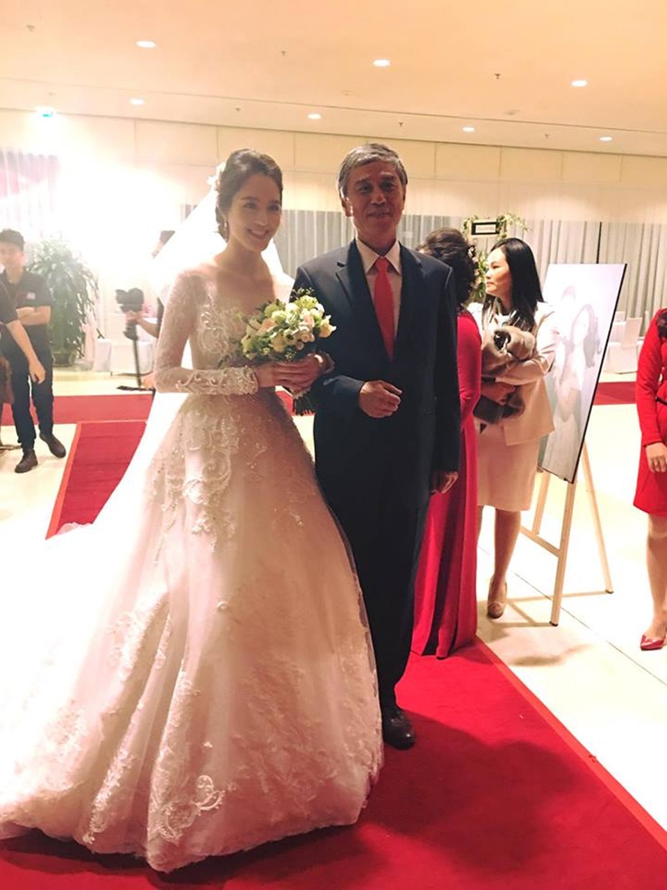 Lộ diện vị hôn phu điển trai của Á hậu Hoàng Anh - 12 Á hậu Hoàng Anh được bố dắt tay vào nơi làm lễ và đặt tay lên chú rể. Tiếp đó, chú rể dịu dàng nắm tay cô dâu bước lên sân khấu. (Ảnh: Mai Phan).
