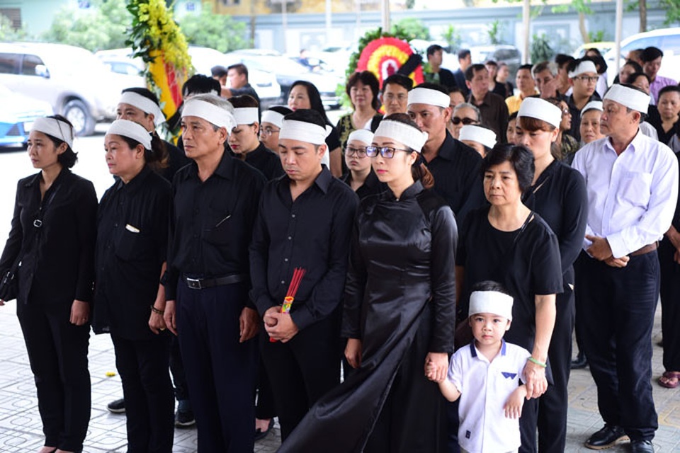Người thân, đồng nghiệp nghẹn ngào bên linh cữu nghệ sỹ Duy Thanh - 1 Con gái nghệ sỹ Duy Thanh (áo dài đen) cùng người thân trong đám tang nghệ sỹ. Ảnh: HTL.