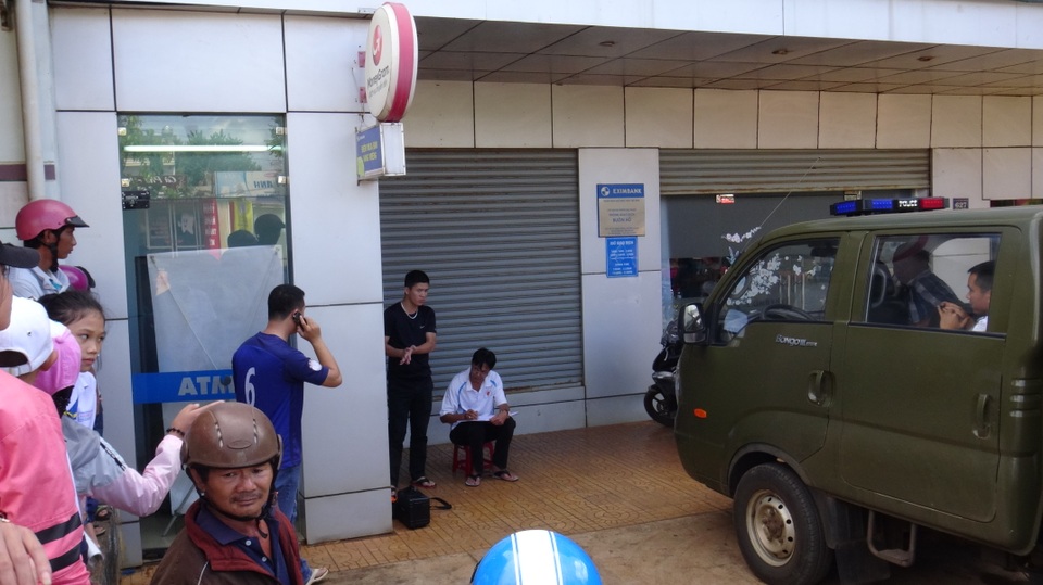 Dùng xà beng cạy trụ ATM trộm tiền - 1 Người dân hiếu kỳ đến xem dựng lại hiện trường (ảnh T.H)
