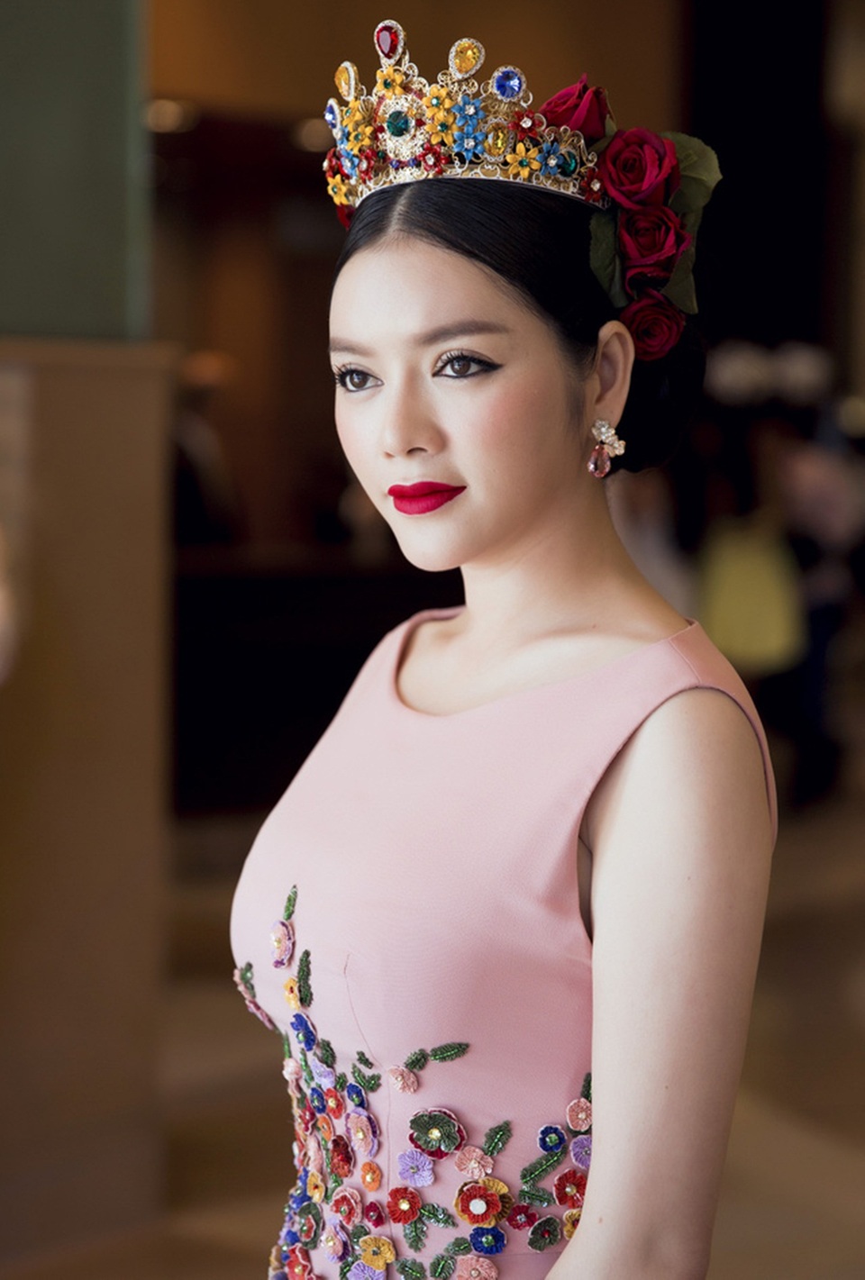 Lý Nhã Kỳ chọn phong cách nữ hoàng mùa xuân. Vương miện được đính đá quý nhiều màu cài thêm những bông hồng quyến rũ.