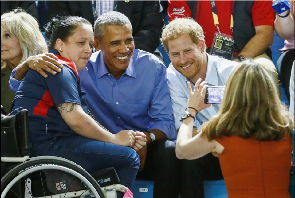 Ông Obama chụp ảnh cùng Hoàng tử Anh Harry và một vận động viên tại Canada (Ảnh: Reuters)