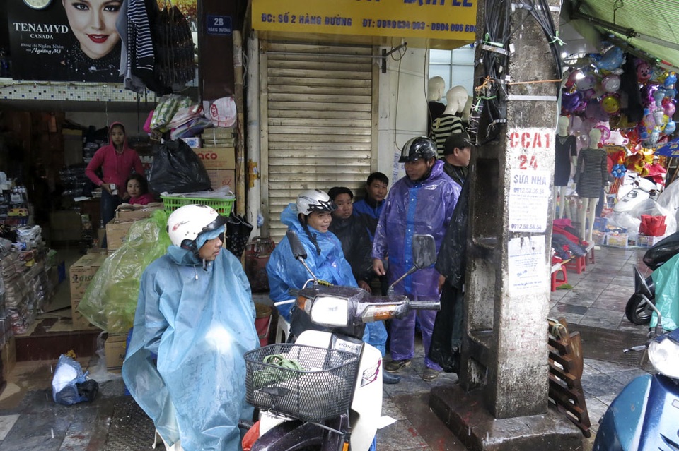 Nhịp sống Hà Nội trong mưa lạnh triền miên - 13
Mưa triền miên nên rỗi việc, những người làm nghề chở hàng thuê trên phố Hàng Đường chỉ còn biết ngồi tán gẫu giết thời gian.
