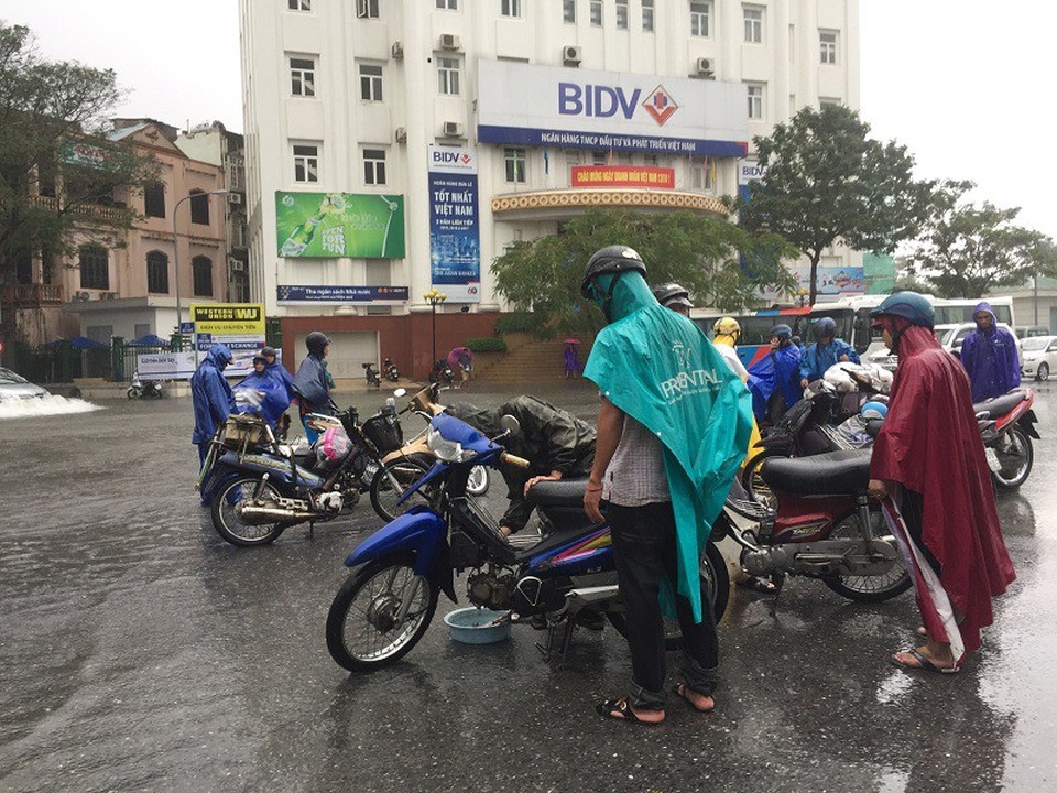 Mưu sinh trên phố ngập lũ ở Huế hốt bạc triệu mỗi ngày - 4 Hàng loạt xe máy chết máy ở ngã 6 được thợ sửa xe chờ sẵn, làm dịch vụ