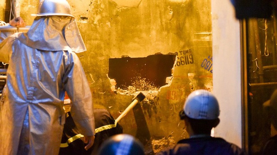Hà Nội: Ngôi nhà 4 tầng trên phố bốc cháy dữ dội - 9
Phía sau của tòa nhà, lực lượng chữa cháy dùng búa tạ phá tường để bơm nước chữa cháy.