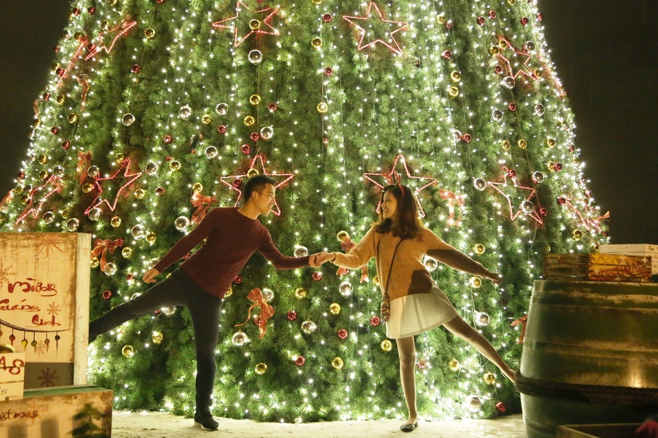 Đôi bạn trẻ này đã đứng dưới cây thông khổng lồ cả tiếng đồng hồ, chụp đến “nóng” máy ảnh vẫn không nỡ rời bước. Khung cảnh lung linh này khiến tình yêu được chắp thêm đôi cánh lãng mạn.