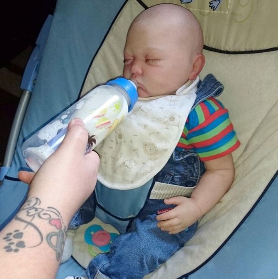 Không thể sinh con, cặp vợ chồng rủ nhau nuôi búp bê - 6 George được cho uống sữa như một đứa trẻ thật sự