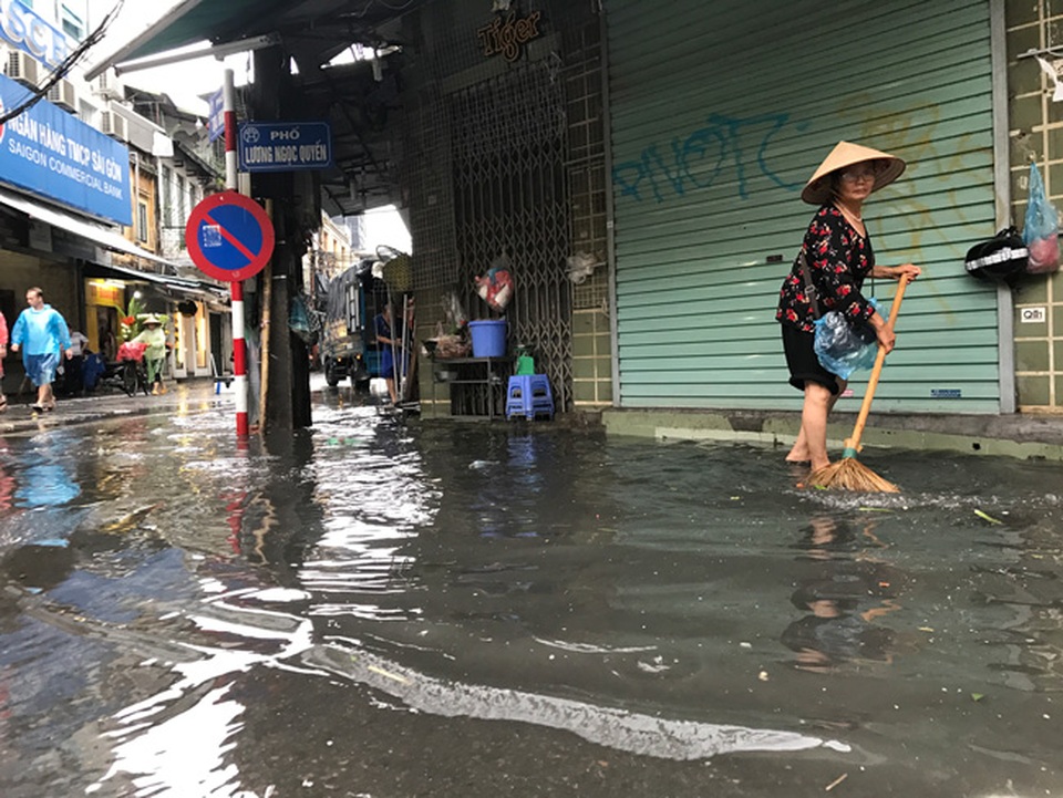 Khách Tây lạ lẫm xem phố cổ Hà Nội thành "biển nước" sau bão - 10 Mùi hôi thối từ cống bốc lên khi nước bắt đầu rút.