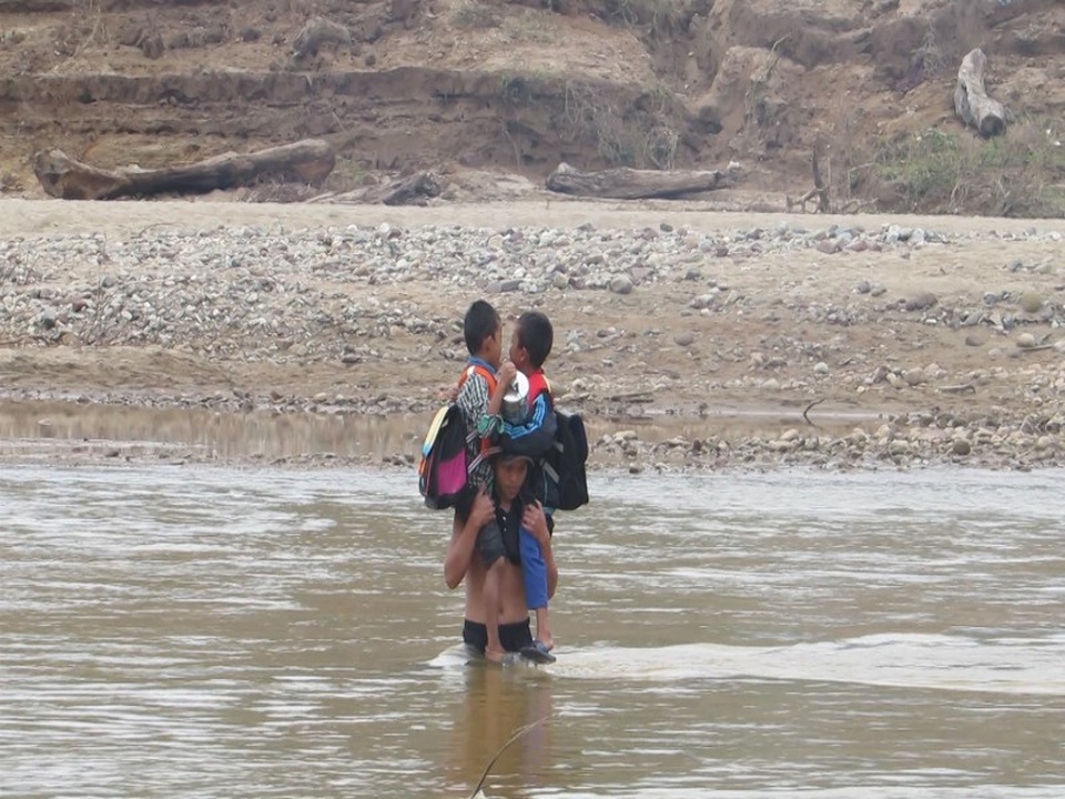 
Không có săm, phụ huynh phải cõng học sinh trên vai rồi vượt sông
