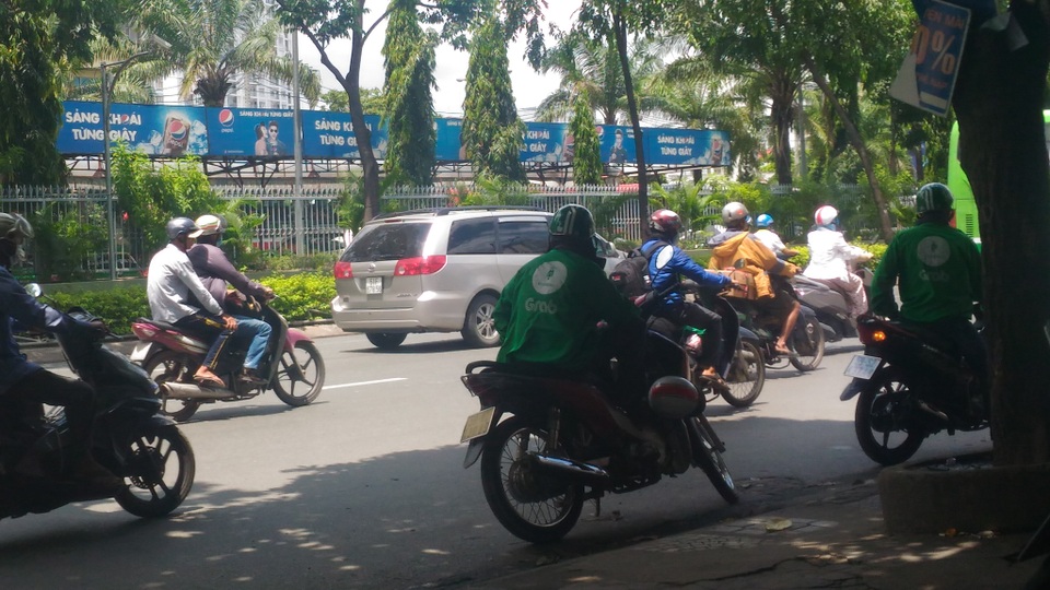 “Cuộc chiến” xe ôm: Suýt đổ máu vì xâm phạm lãnh địa Q "tóc dài" - 5 Tài xế GrabBike đứng đón khách ở phía đối diện bến xe miền Đông.