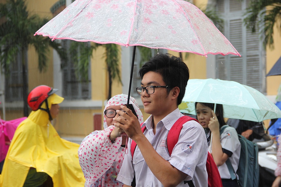 TPHCM: Thí sinh lại đội mưa về sau buổi thi môn Ngoại ngữ - 3 Dưới cơn mưa, nhiều thí sinh gương mặt hớn hở chấp nhận ướt mưa về nhà.
