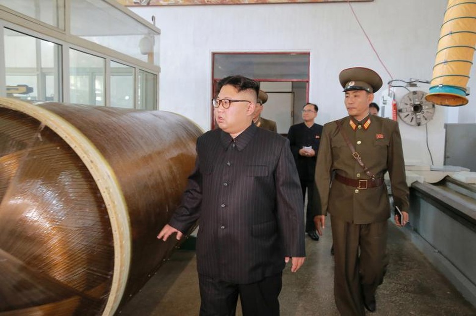 Chuyến thị sát cơ sở tên lửa giữa lúc “nước sôi lửa bỏng” của ông Kim Jong-un - 8 Trong bức ảnh này, ông Kim Jong-un được nhìn thấy đứng cạnh một vật thể hình trụ lớn màu đồng. Các chuyên gia cho rằng đây có thể là vỏ tên lửa bằng chất dẻo gia cố và việc sử dụng nguyên liệu này sẽ giúp trọng lượng của tên lửa mới nhẹ hơn so với các phiên bản tên lửa làm từ kim loại truyền thống, từ đó cho phép tên lửa Triều Tiên bay xa hơn.