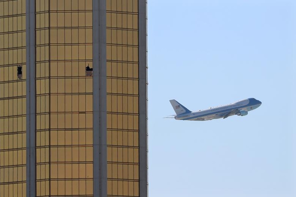 Ông Trump mời nạn nhân vụ xả súng Las Vegas tới Nhà Trắng - 2 Chuyên cơ Không Lực Một chở nhà lãnh đạo Mỹ và phu nhân bay qua khách sạn Mandalay Bay với 2 vết kính vỡ trên tầng 32 - nơi tay súng Stephen Paddock thực hiện vụ tấn công nhằm vào đám đông khán giả tham dự lễ hội âm nhạc tại Las Vegas. (Ảnh: Reuters)