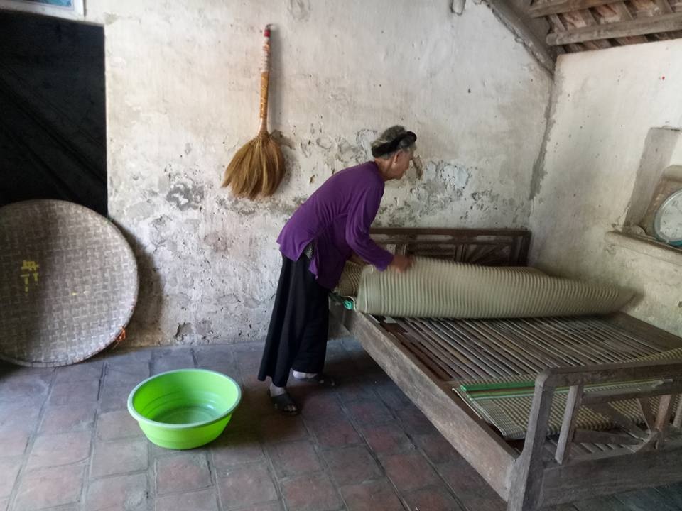 Vợ liệt sĩ mong có căn nhà mưa không dột, nắng không chói vào để thờ chồng - 2 Trời mưa khiến cụ phải dùng chậu hứng nước và cuốn chiếu lại để nước mưa không chảy vào