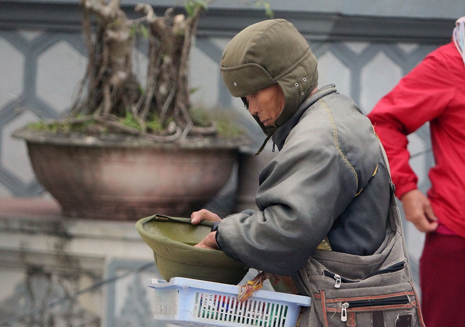 Ăn xin lẩn khuất khắp Chợ Viềng - 3
Họ mang dáng vẻ nghèo khổ, có người mang theo rỏ kẹo nhưng thường không bán mà ngửa tay xin tiền du khách.