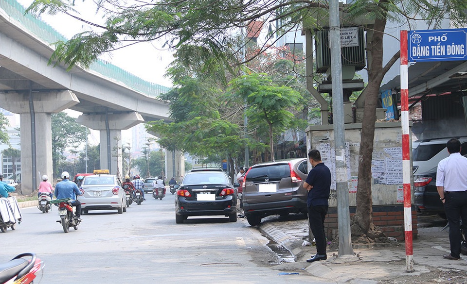 
Đoạn phố Đặng Tiến Đông giao với Hoàng Cầu, một tiệm rửa xe ô tô để nhiều xe đỗ dưới lòng đường
