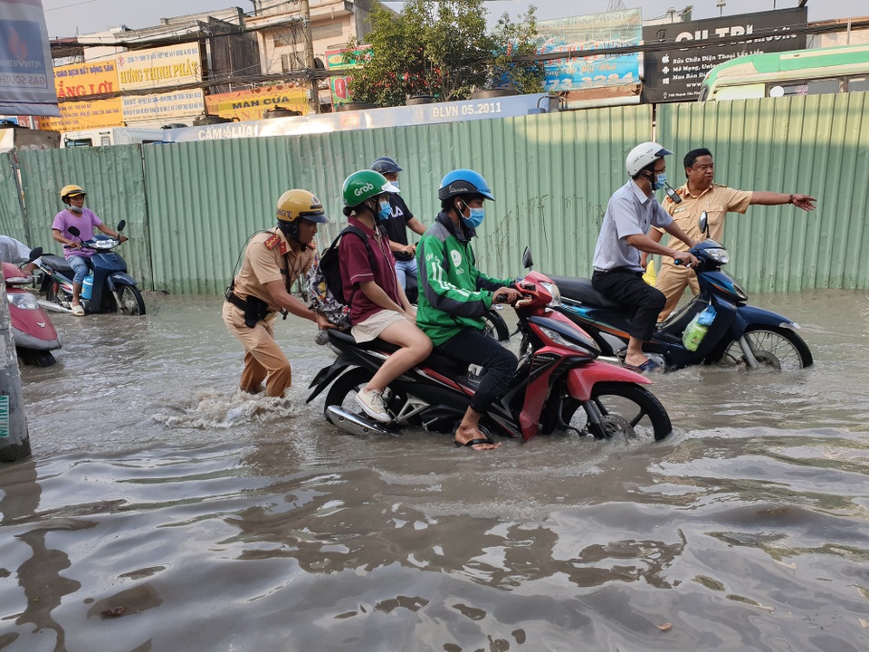 Triều cường bủa vây Sài Gòn, Cần Thơ - 15 Cảnh sát giao thông giúp dân đẩy xe qua điểm ngập
