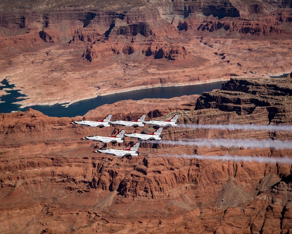 Phi đội Thunderbirds bao gồm 8 phi công, 6 trong số đó là phi công biểu diễn, 4 quan chức hỗ trợ, 3 người dân thường và hơn 130 nhân viên khác. Trong ảnh: Đội Thunderbirds bay thành đội hình trên Lake Powell.