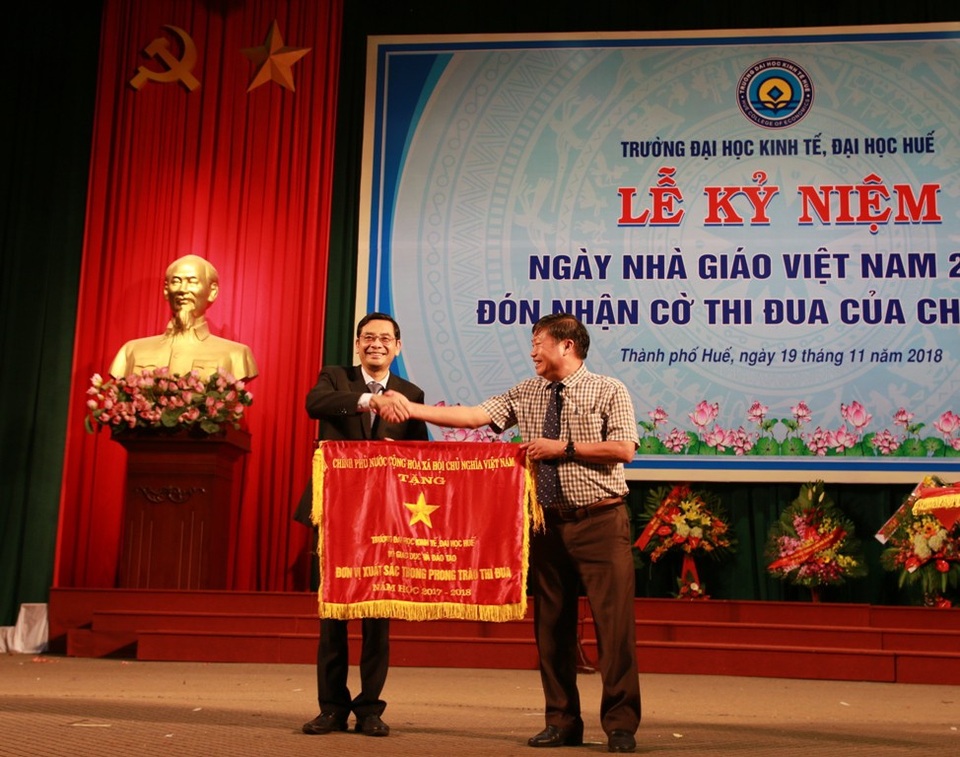 Trường Đại học Kinh tế Huế đón nhận cờ thi đua của Chính phủ - 1 Ông Nguyễn Thái Sơn, Trưởng Ban Tuyên giáo Tỉnh ủy Thừa Thiên Huế (phải) trao cờ thi đua của Chính phủ cho Hiệu trưởng nhà trường (trái)