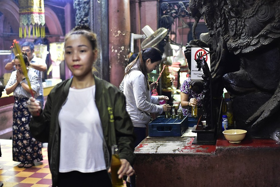 Du khách nước ngoài thích thú trước hình ảnh người dân đi chùa ngày rằm - 5 
Phật tử đang nhận dầu thắp đèn lễ