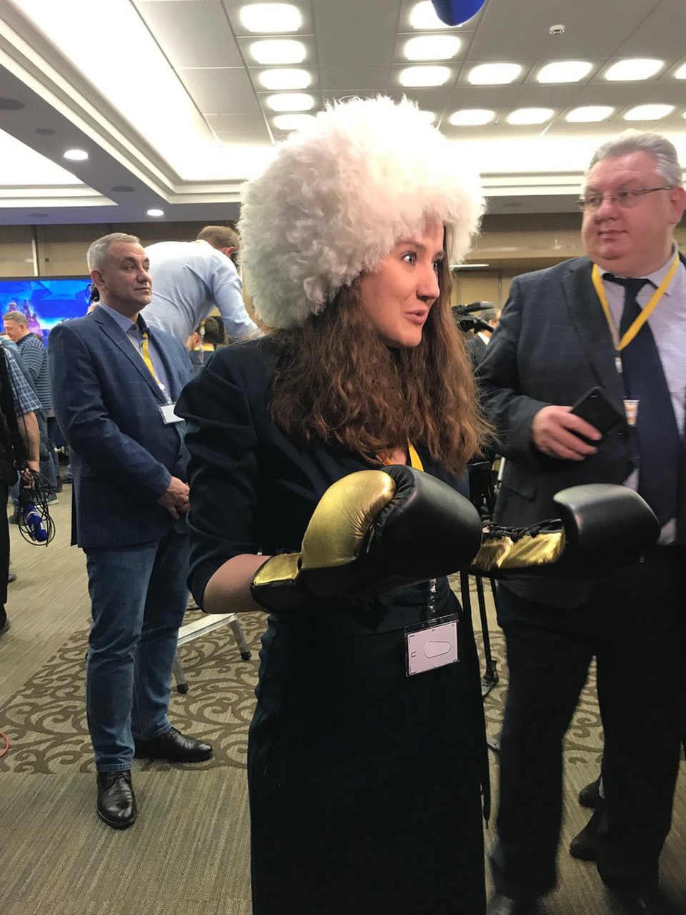 Một nhà báo tới tham gia họp báo với một chiếc mũ lông lớn và một đôi găng tay đấm bốc.