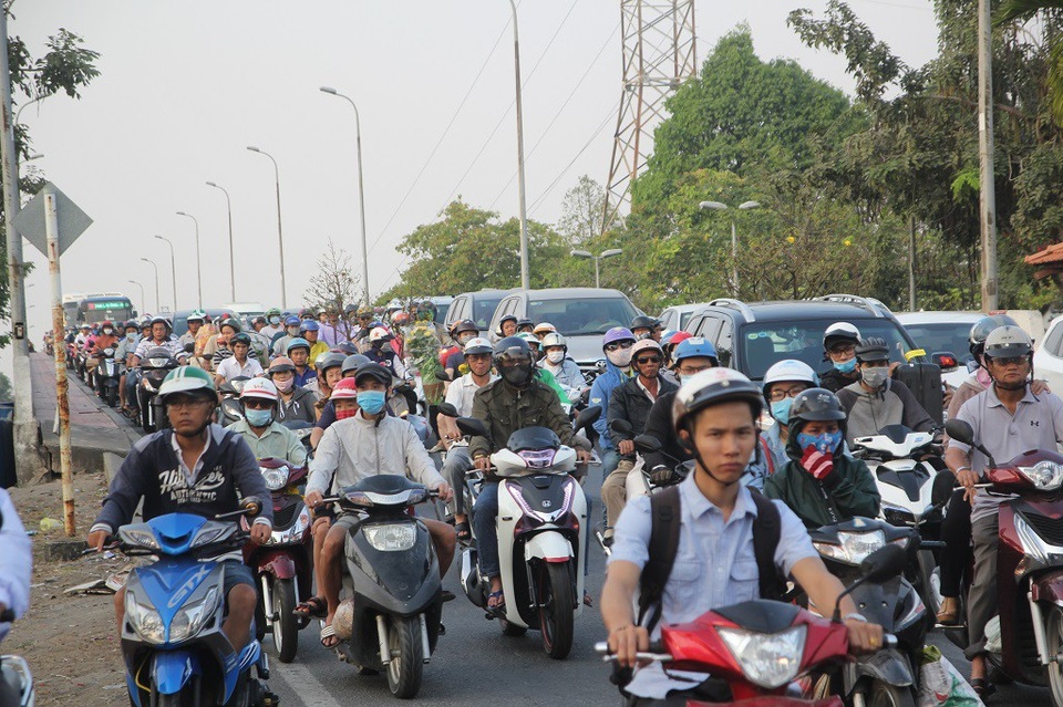 Chiều 28 Tết, giao thông ùn ứ ở cửa ngõ Đông Bắc TPHCM - 1 Dòng xe nối đuôi di chuyển khó khăn qua cầu Bình Triệu và bến xe Miền Đông