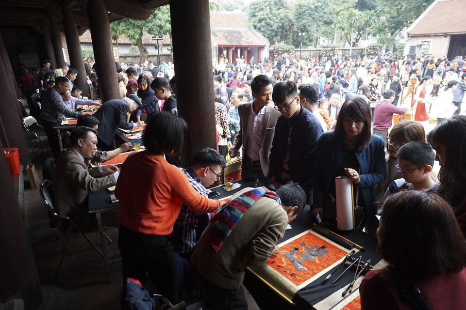 Hàng nghìn người tới Văn Miếu xin chữ đầu năm - 2
Trong sân Văn Miếu, rất đông người xếp hàng chờ xin chữ từ các ông đồ.