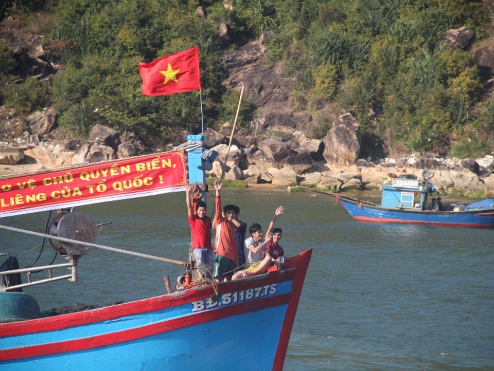 Các ngư dân trẻ vẫy tay chào tạm biệt người thân để vươn khơi.