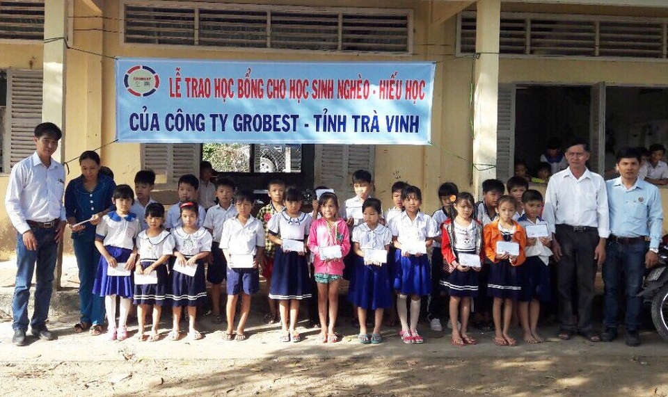 Grobest Việt Nam trao 160 suất học bổng đến các em học sinh nghèo tỉnh Trà Vinh - 2 ông Nguyễn Đức Học – Trưởng khu vực công ty Grobest tỉnh Trà Vinh trao học bổng cho các em học sinh trường tiểu học Vinh Kim