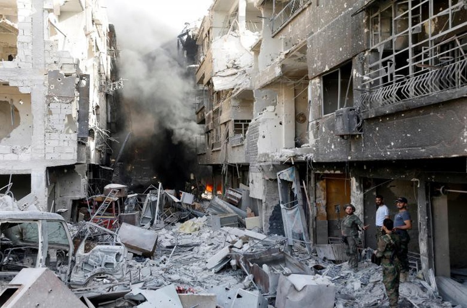Thủ đô Syria hoang tàn sau 7 năm chìm trong bom đạn - 9 Lửa vẫn cháy bên trong các tòa nhà bị trúng hỏa lực tại Damascus. Xe ô tô và các đồ đạc đều bị thiêu rụi trơ khung.