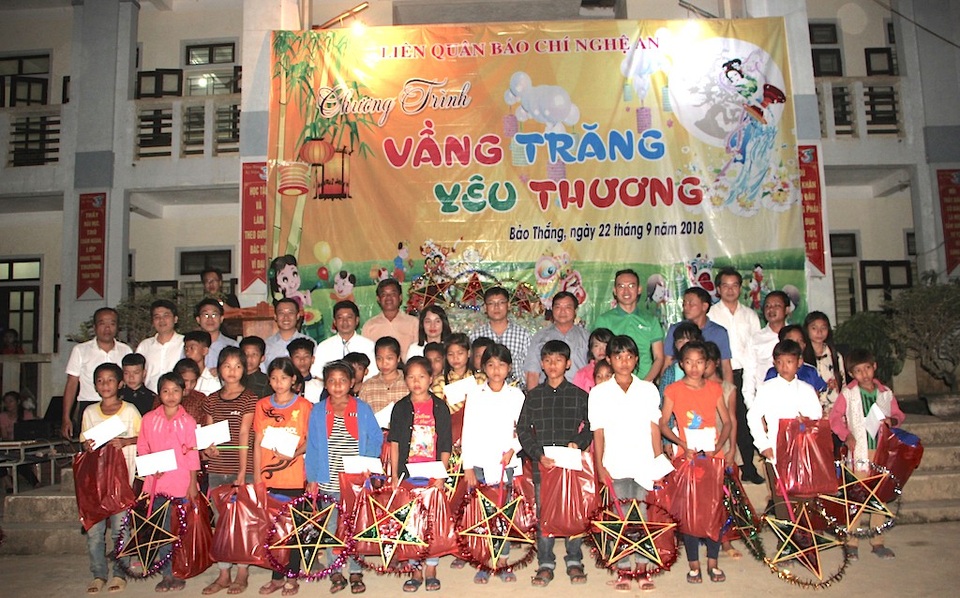 Ban tổ chức trao học bổng cho trẻ em nghèo.