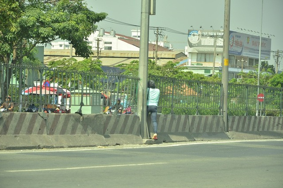 
Cô gái cố len qua một dải phân cách kiên cố
