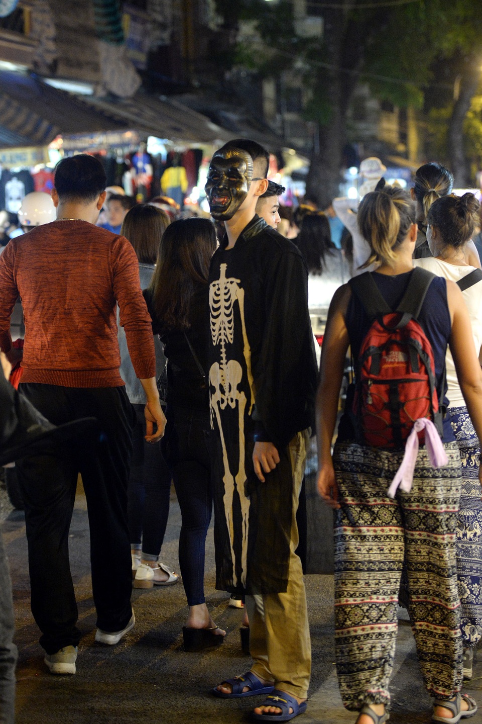 Không chỉ đeo mặt nạ, nhiều thanh niên còn diện thêm cả quần áo và các phụ kiện lượn lờ giữa dòng người.