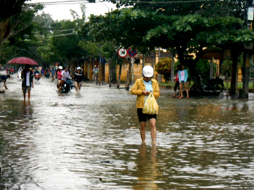 Nước chưa rút hoàn toàn nên người dân vẫn phải lội nước hoặc dùng ghe để di chuyển.