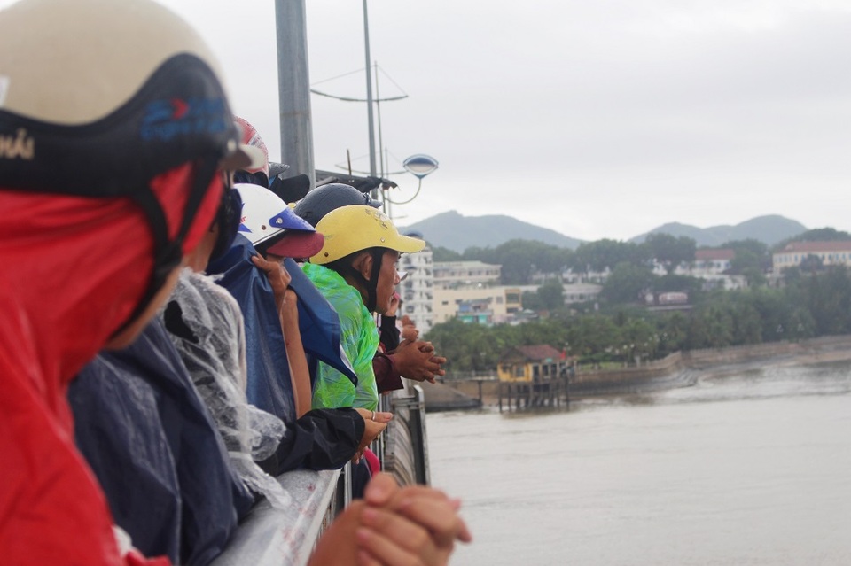 Người dân hiếu kỳ đứng trên cầu Trần Phú (Nha Trang) để theo dõi công tác tìm kiếm 2 cha con mất tích