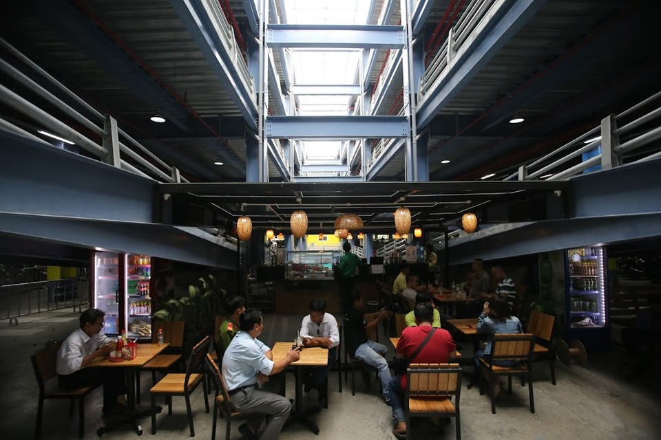 Một quán cà phê được mở dưới phần dốc lên xuống khu vực để xe máy để phục vụ khách có nhu cầu.