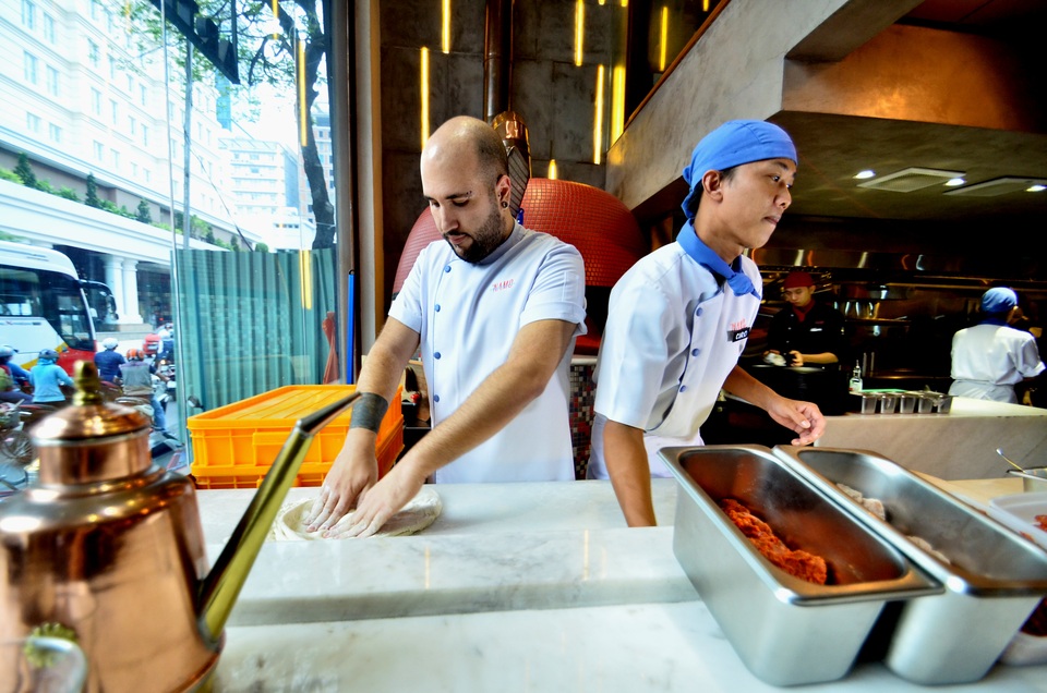 Có 2 đầu bếp thực hiện chiếc bánh pizza dài 1 mét.