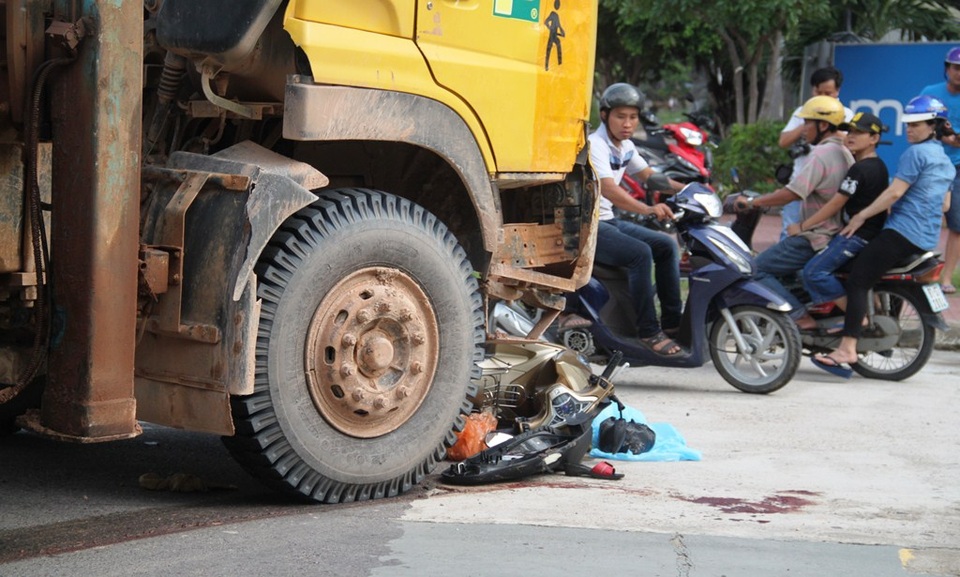 Xe máy nằm gọn dưới bánh trước xe cẩu